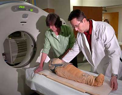 A mummified toddler is prepared for a CT scan, in order to determine whether a spear in it skull was what killed the child.