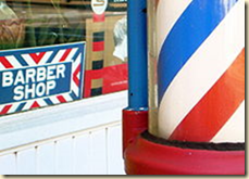 A US barber pole in front of a barber shop